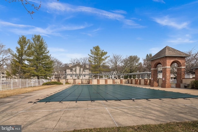 community pool featuring a patio and fence