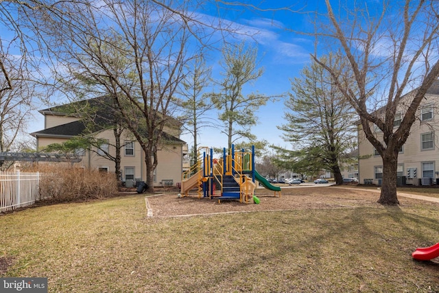 communal playground with a lawn and fence