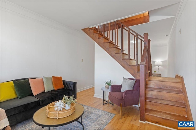 living room with ornamental molding, stairs, and wood finished floors