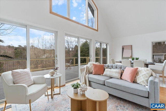 living room with wood finished floors and a towering ceiling