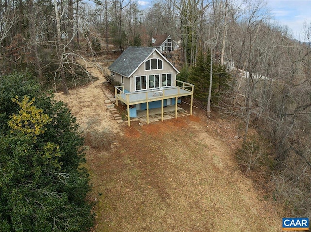 exterior space featuring a wooden deck and driveway