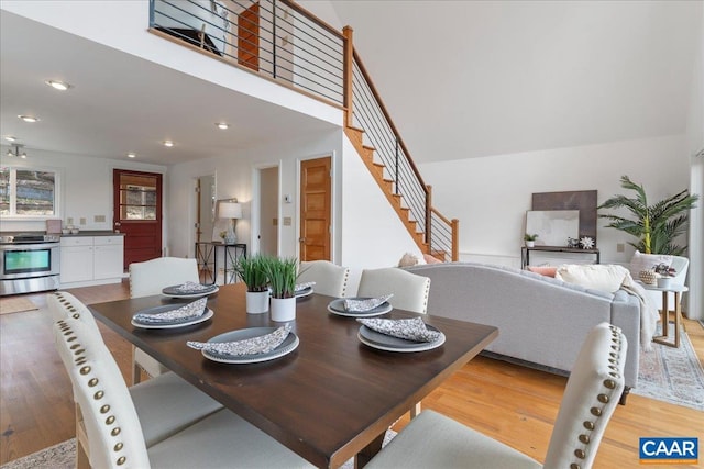 dining area with recessed lighting, stairway, and light wood-style flooring