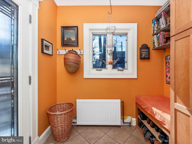 interior space with tile patterned floors, radiator, and baseboards