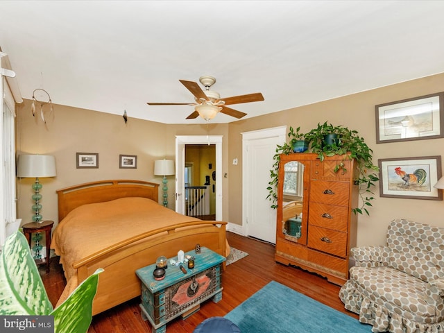 bedroom with baseboards, wood finished floors, and a ceiling fan