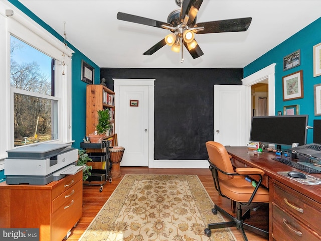 home office with ceiling fan and wood finished floors