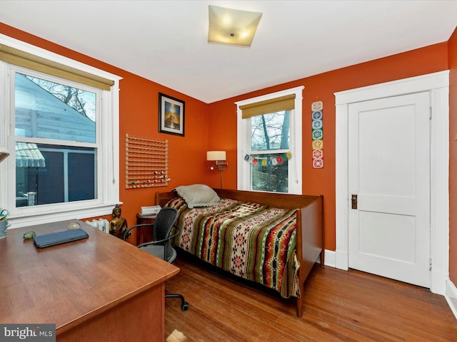 bedroom featuring baseboards and wood finished floors