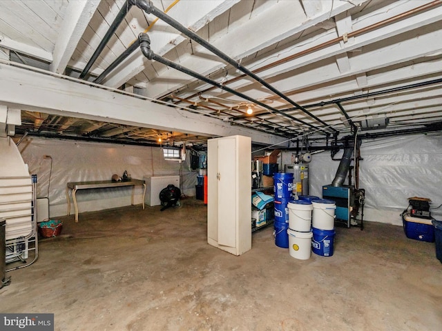 unfinished basement featuring electric water heater