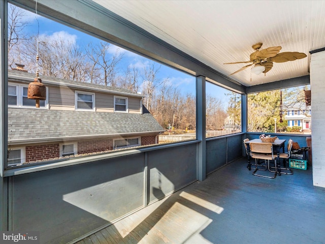 sunroom featuring a ceiling fan