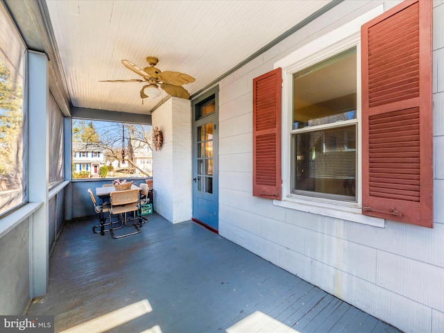 unfurnished sunroom featuring wooden ceiling and a ceiling fan