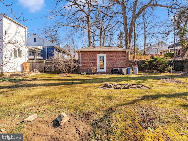 view of yard featuring fence and a fire pit