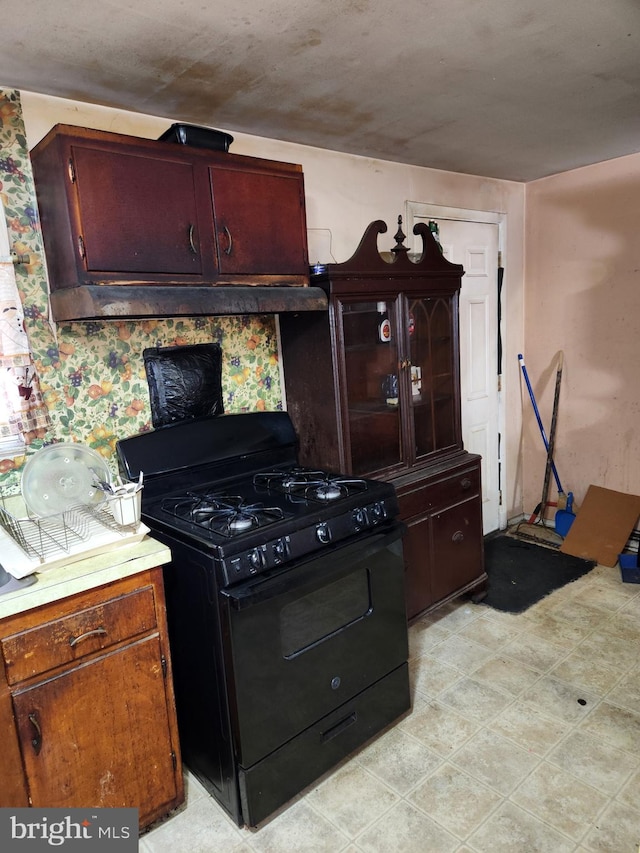 kitchen featuring light countertops and black range with gas cooktop