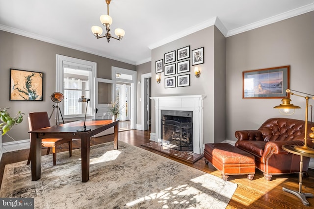 office area featuring a high end fireplace, ornamental molding, baseboards, and wood finished floors