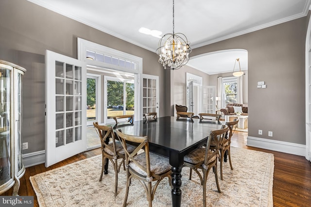 dining space with french doors, baseboards, and crown molding