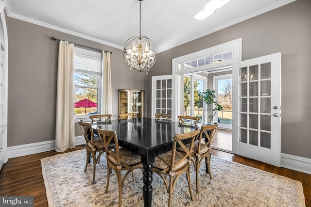 dining room with dark wood finished floors, baseboards, and a wealth of natural light