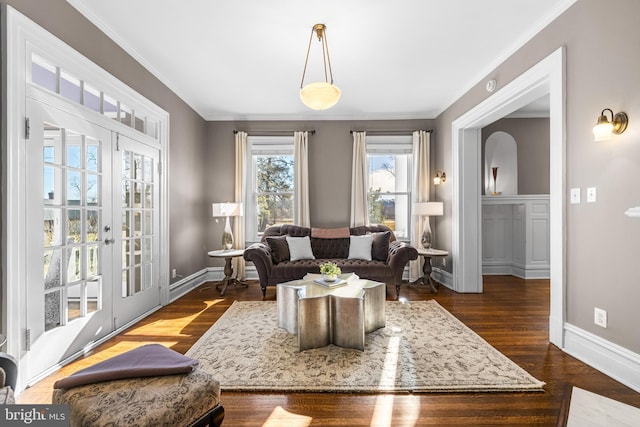 living room with crown molding, dark wood-type flooring, and baseboards