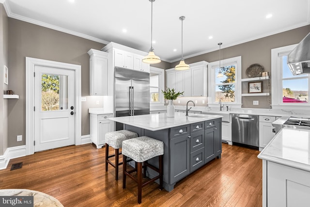 kitchen featuring a center island, stainless steel appliances, crown molding, and open shelves