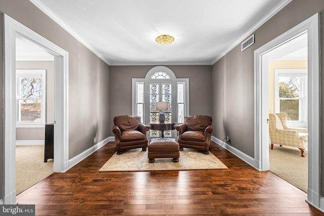 living area featuring visible vents, ornamental molding, baseboards, and dark wood-style flooring