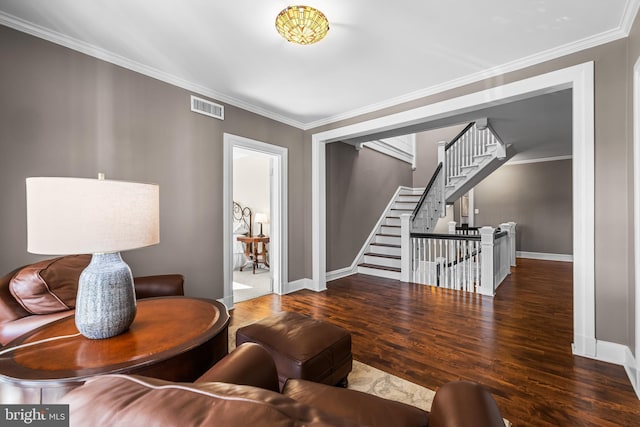 living room with visible vents, wood finished floors, and crown molding