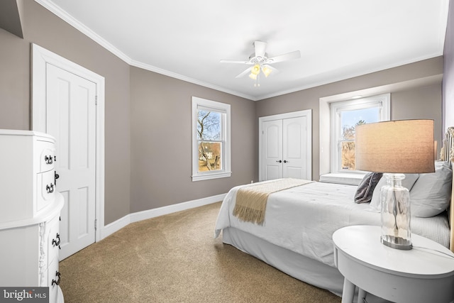 bedroom with ornamental molding, a ceiling fan, a closet, carpet floors, and baseboards