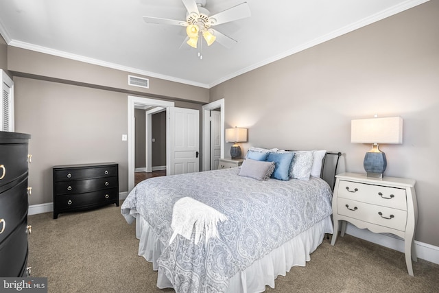 bedroom featuring visible vents, baseboards, carpet flooring, and crown molding