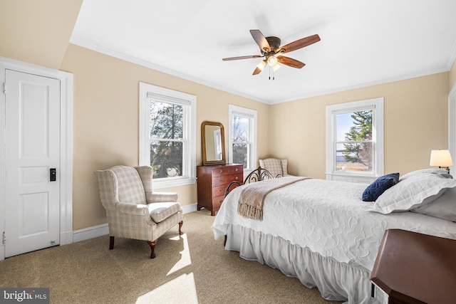 bedroom with multiple windows, carpet floors, and ornamental molding