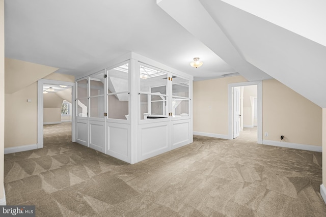 bonus room with vaulted ceiling, baseboards, and carpet floors