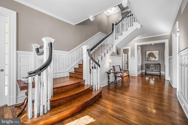 interior space featuring stairway, ornamental molding, and wood finished floors