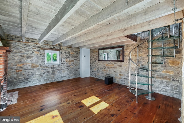 unfurnished living room featuring beamed ceiling and hardwood / wood-style flooring