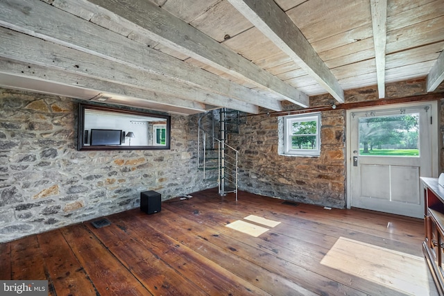 empty room with beam ceiling, wooden ceiling, visible vents, and wood-type flooring