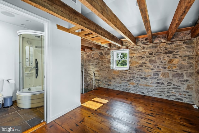 interior space with beam ceiling and hardwood / wood-style flooring