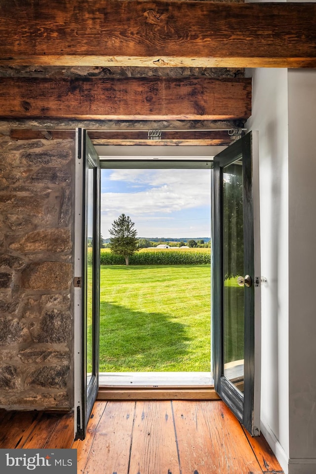 doorway to outside with a wealth of natural light and hardwood / wood-style floors