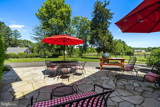 view of patio with outdoor dining area and fence