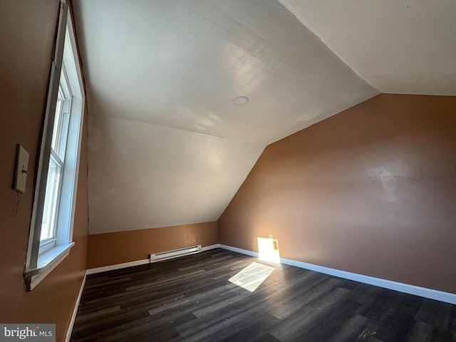 bonus room featuring dark wood finished floors, visible vents, baseboards, and lofted ceiling