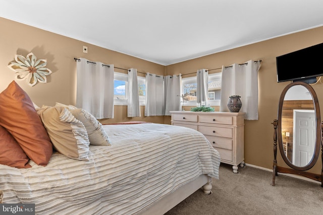 bedroom with baseboards and light carpet