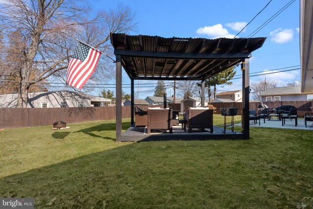 view of yard featuring a patio, a fire pit, and a fenced backyard