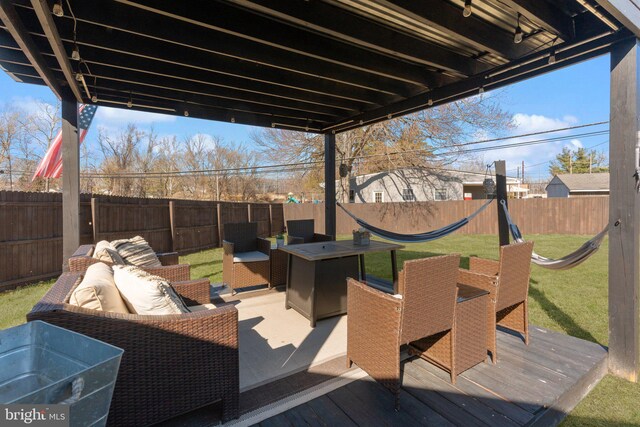 view of patio featuring an outdoor living space, a wooden deck, and a fenced backyard