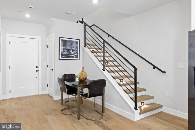 foyer featuring light wood finished floors, visible vents, recessed lighting, and baseboards
