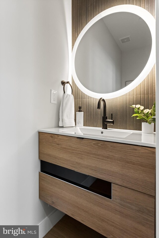 bathroom featuring vanity and visible vents