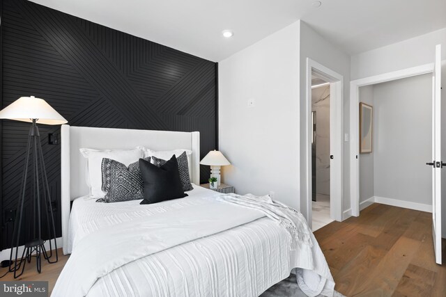 bedroom with recessed lighting, baseboards, and wood finished floors
