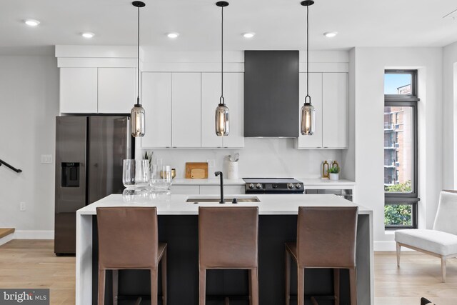 kitchen with extractor fan, stainless steel fridge with ice dispenser, light countertops, modern cabinets, and a sink