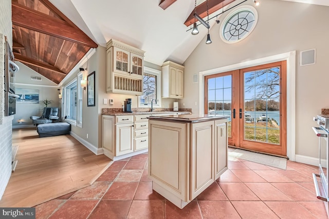 kitchen featuring french doors, baseboards, cream cabinetry, and visible vents