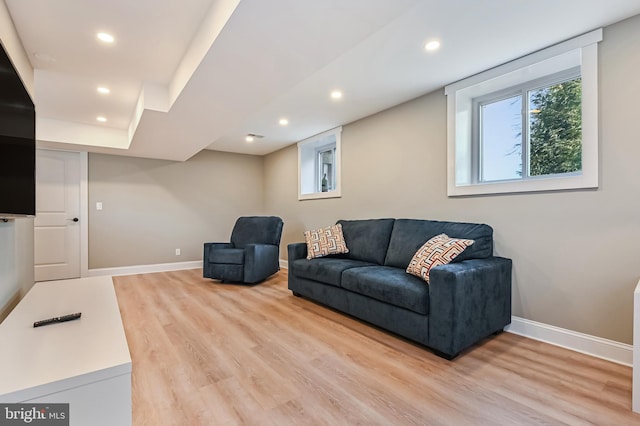 living room featuring light wood-style flooring, recessed lighting, and baseboards