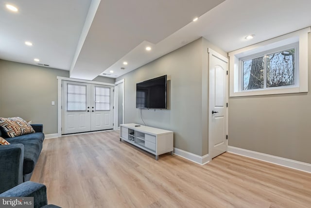 living area with visible vents, recessed lighting, french doors, light wood finished floors, and baseboards