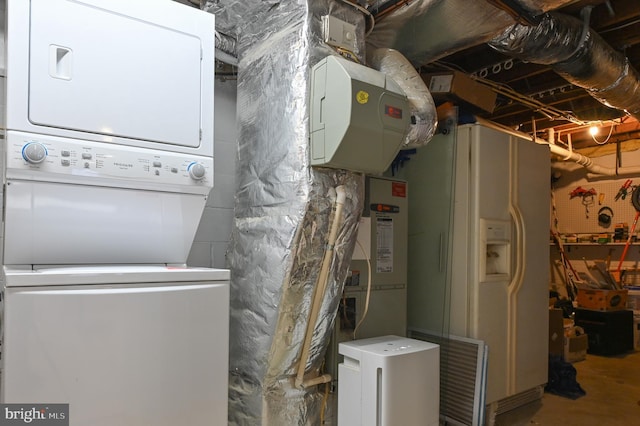 utility room with stacked washing maching and dryer