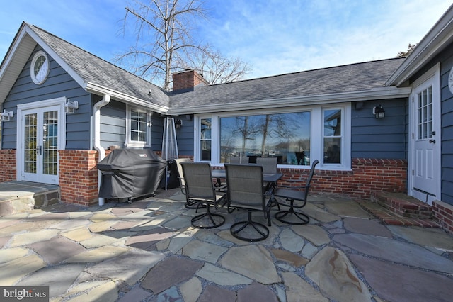 view of patio featuring area for grilling, french doors, and outdoor dining area