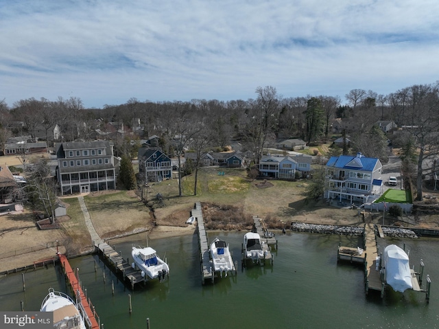 drone / aerial view featuring a water view and a residential view