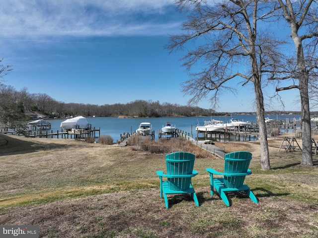 view of dock featuring a lawn, a water view, and boat lift