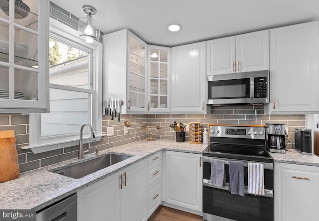 kitchen featuring decorative backsplash, appliances with stainless steel finishes, and a sink