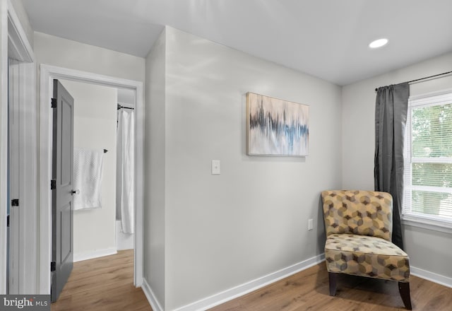 living area with recessed lighting, baseboards, and wood finished floors