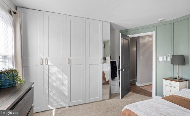 bedroom featuring light carpet